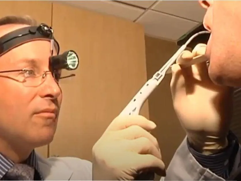 Clinician examining a patient wearing a head lamp